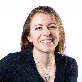 Dr. Kady Lyons smiles at the camera in a black shirt and glass necklace. The photo is a headshot perspective.