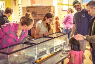 Maria Letourneau, right, speaks to visitor at Marine Sciences table