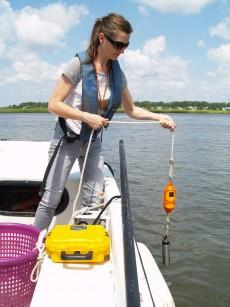 UGA Skidaway Institute researcher LeeAnn DeLeo lowers the sensor to measure conductivity, temperature and depth from the surface to the bottom