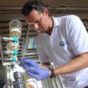 Dr. Marchetti in a white polo preps a phytoplankton sample