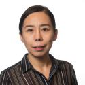 Dr. Jianqiu Zheng smiles in a headshot framed by a white background. She is wearing a brown and black vertical stripe button up